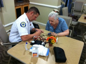 Lt. Ryan Hathaway with Okeechobee County Fire Rescue taking vital signs for seniors.