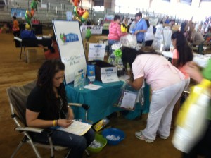 Okeechobee County Health & Safety Expo attendees stopping at Action Home Care's booth. 